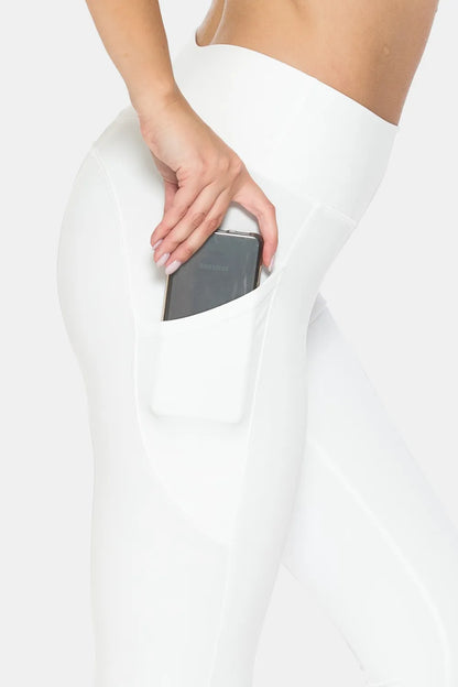 Close up of Comfee white leggings with deep side pocket holding smartphone