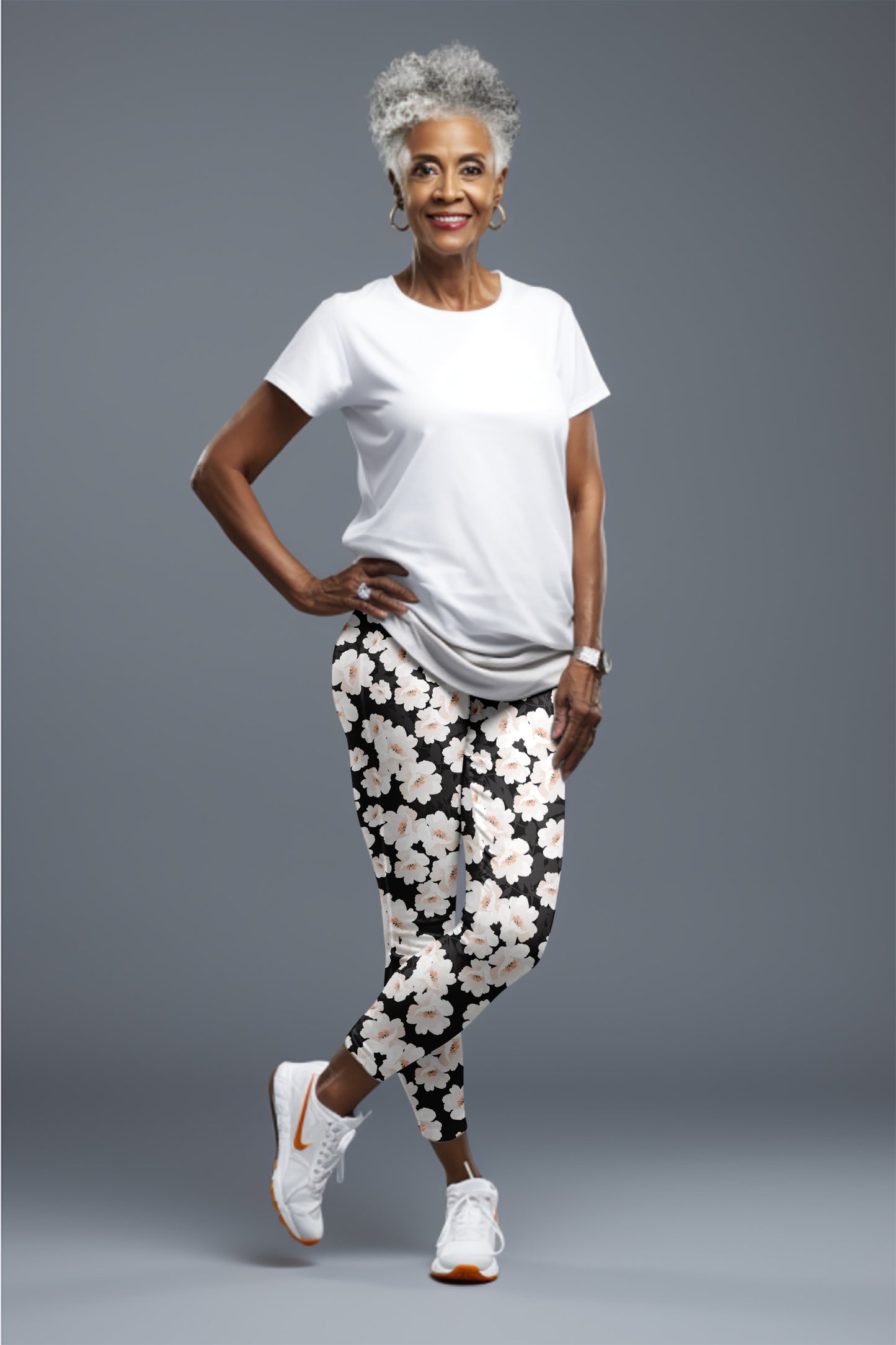 Relaxed portrait of Black woman in trendy outfit, confident pose.